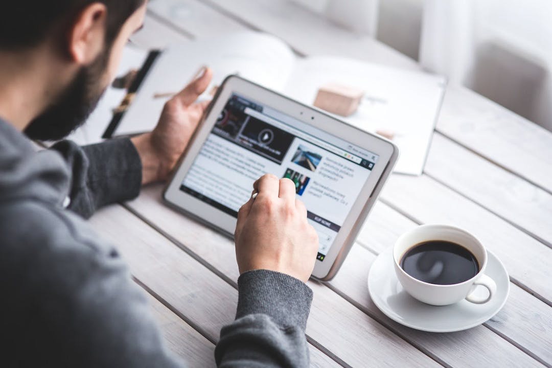 Man with ipad and coffee