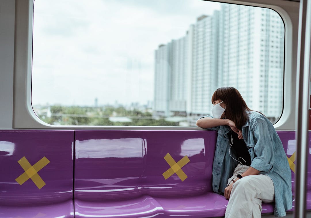 woman looking out the train